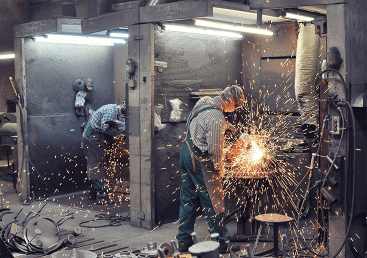 workers in a foundry grind castings with a grinding machine heavy industry workplace 3869278